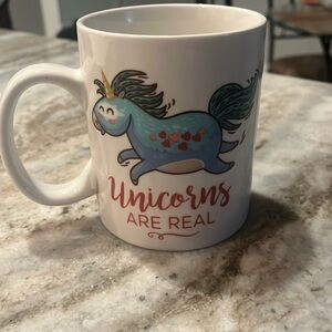 Coffee mug says “unicorns are real”